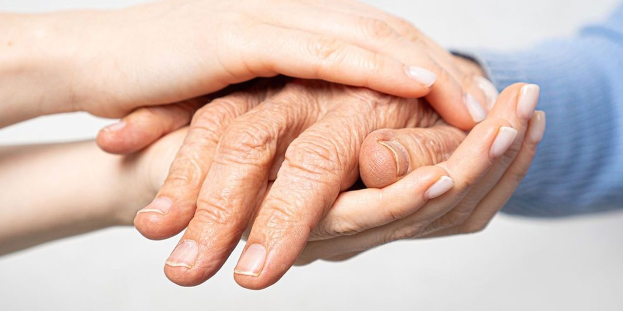 Young hands hold old hands. Support for the elderly concept.