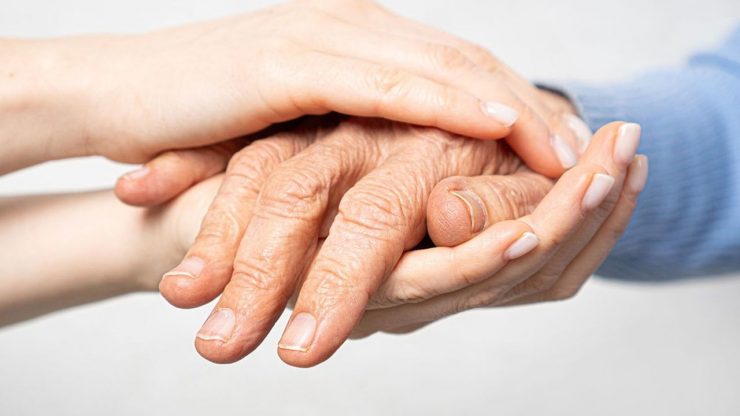 Young hands hold old hands. Support for the elderly concept.